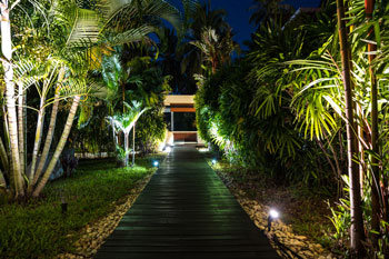 Outdoor landscape lighting a walkway path in Kendall, FL